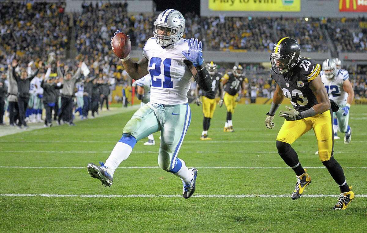 Dallas Cowboys running back Ezekiel Elliott (21) scores a fourth quarter touchdown in front of Pittsburgh Steelers free safety Mike Mitchell (23) as the Dallas Cowboys beat the Pittsburgh Steelers 35-30 on Sunday, Nov. 13, 2016 at Heinz Field in Pittsburgh, Pa.