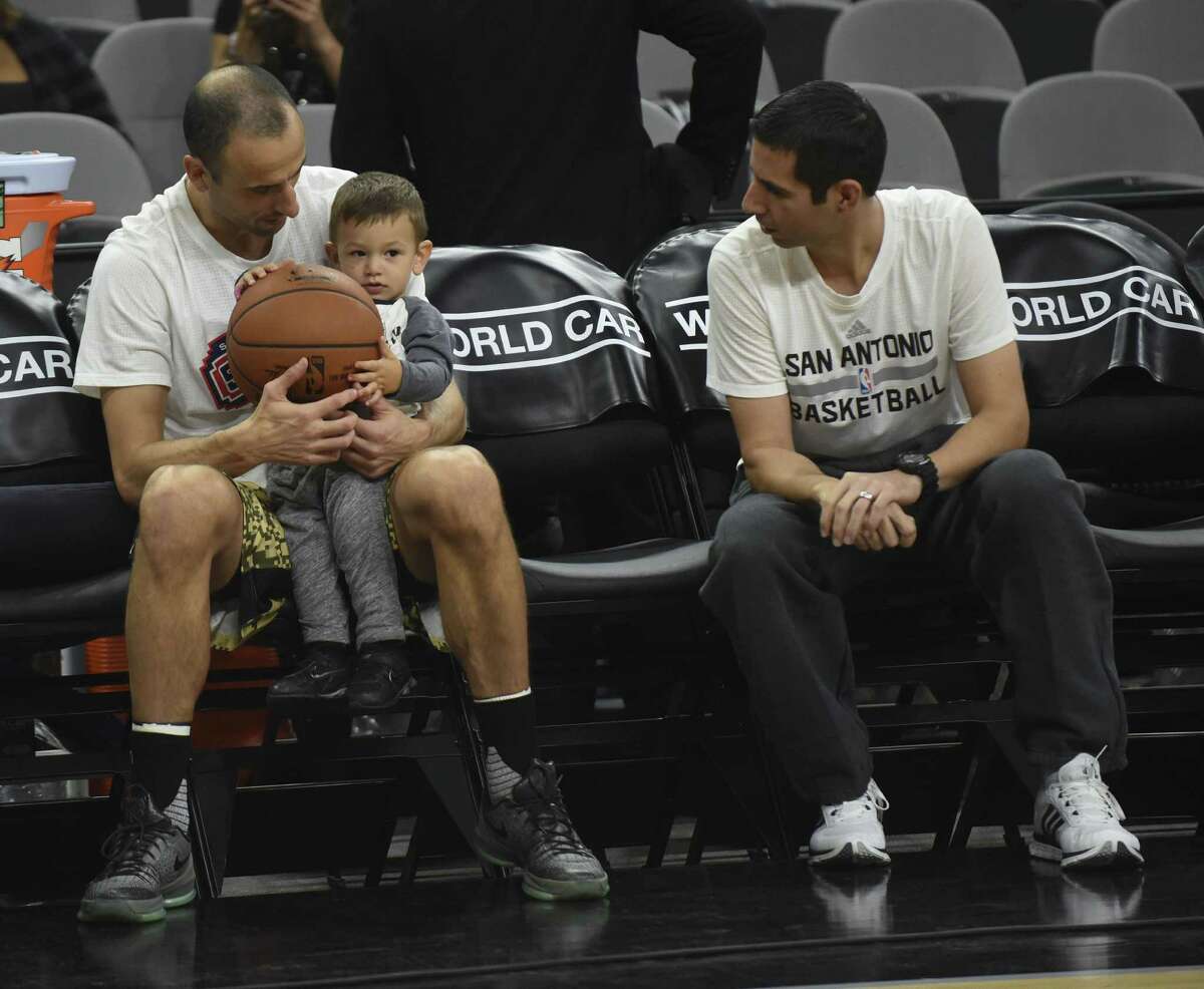 Manu Ginobili and Spurs assistant James Borrego enjoy a moment with one of Ginobii’s sons.