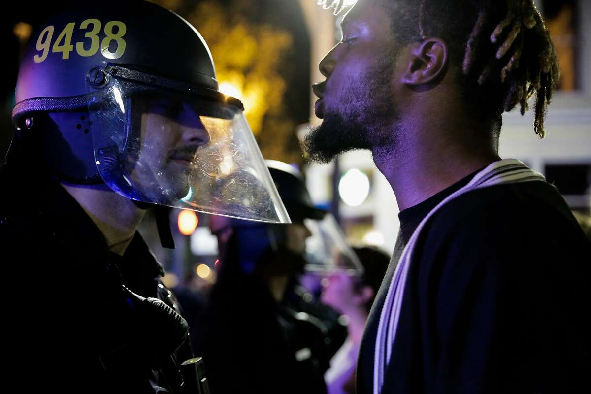 A protester against president-elect Donald Trump yelled at a police officer during a demonstration in Oakland, California, U.S., November 9, 2016.