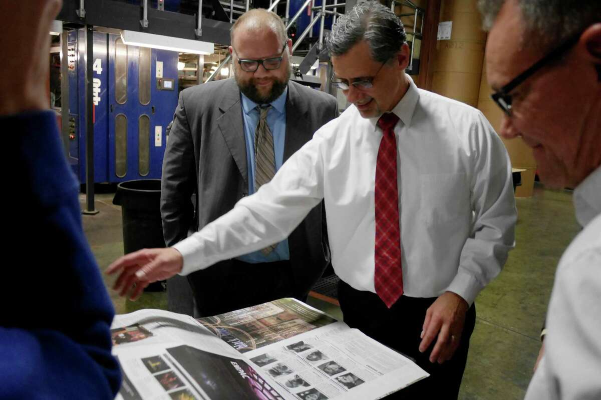 Dave King, left, editor/associate publisher of The Alt, a new alternative weekly, and John DeAugustine, president and publisher of the Schenectady Gazette, look over early copies of the publication inside the press room at the Schenectady Gazette on Monday, Nov. 14, 2016, in Schenectady, N.Y. (Paul Buckowski / Times Union)