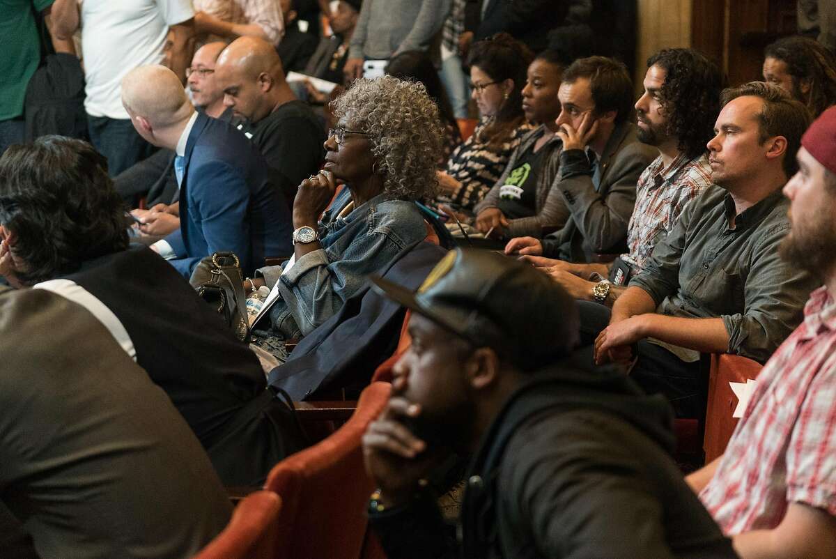 People listen to speakers during a special meeting about cannabis at Oakland City Hall in Oakland, Calif. on Monday, Nov. 14, 2015. The Oakland City Council held a meeting to hear a handful of proposed cannabis laws including a controversial 25% tax on profits made by cannabis businesses.