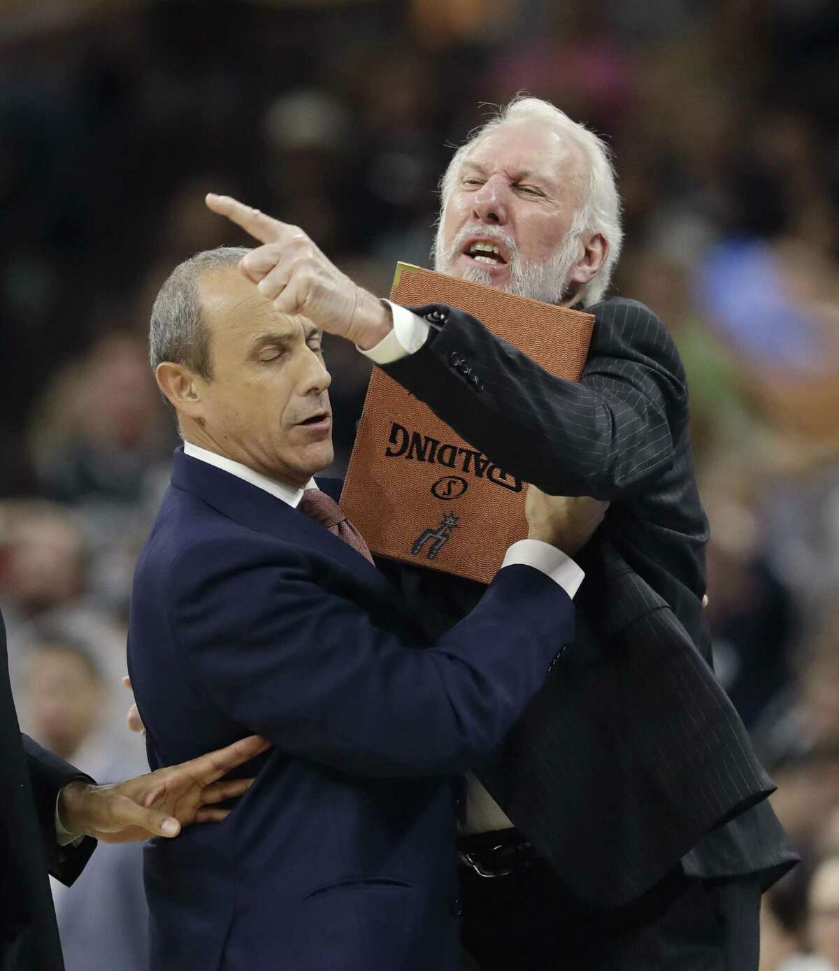 Spurs coach Gregg Popovich is held back by assistant coach Ettore Messina as he argues an official’s call during the first half against the Los Angeles Clippers on Nov. 5, 2016, in San Antonio.