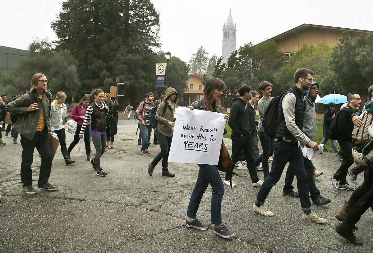 UC Berkeley graduate student in public health and city planning Sarah Skenazy (with large white sign) protests university rules surrounding sexual harassment investigations outside of Wurster Hall at UC Berkeley on Tuesday, November 15, 2016, in Berkeley, Calif.
