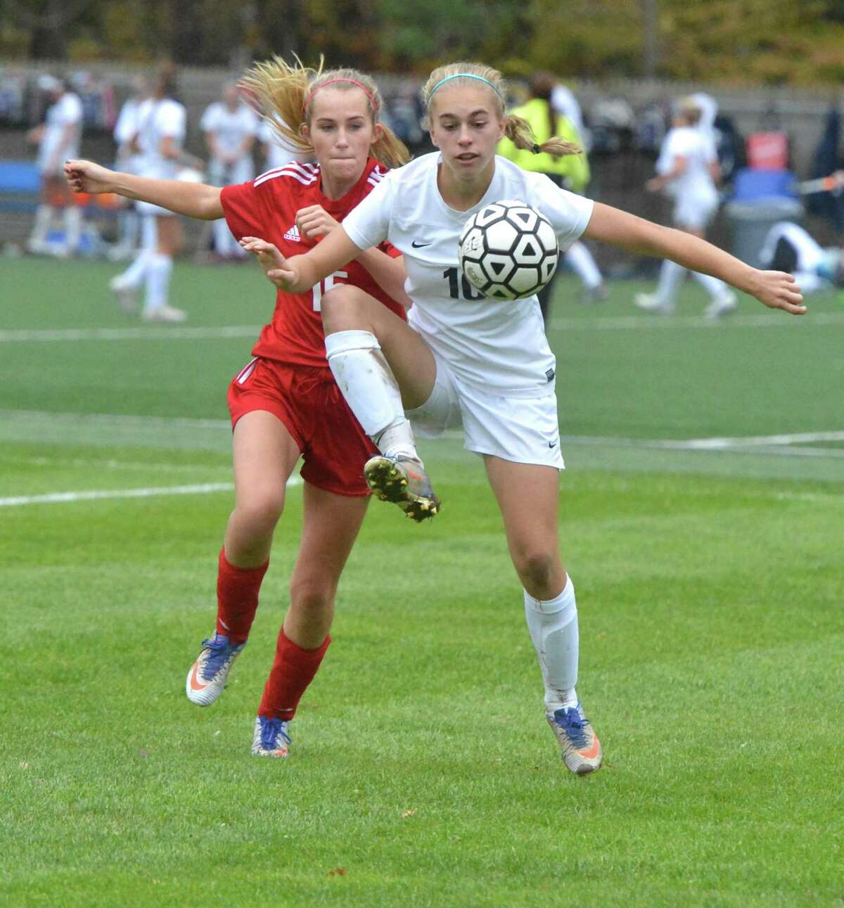 Staples’ Ashley Wright (10) keeps the ball away from New Canaan's Eliza Farley (15) during Class LL girls soccer at Staples High School on Wednesday Westport.