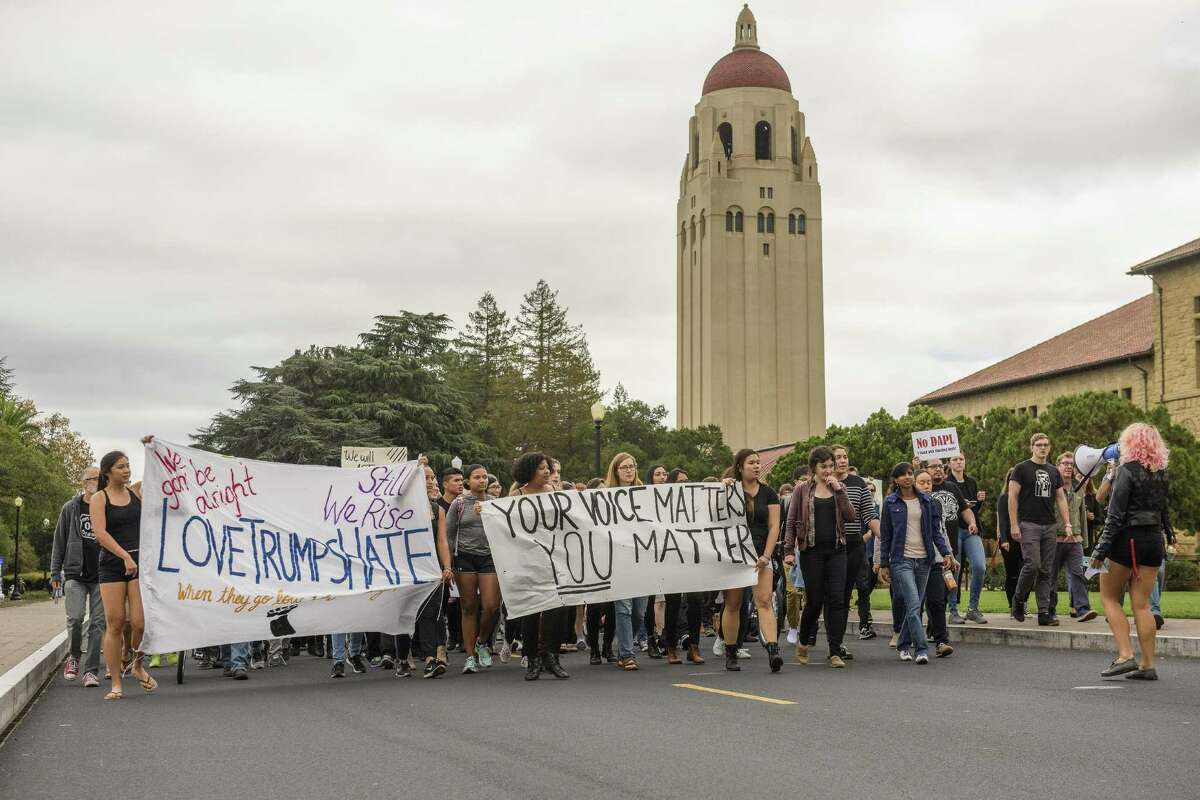 Hundreds of students march on Serra Street to the Main Quadrangle of Stanford University in an anti-Trump protest Tuesday.