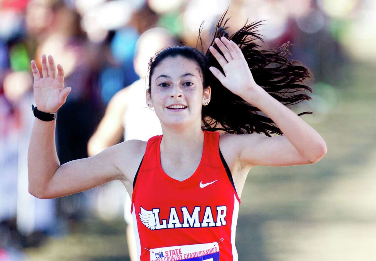 Julia Heymach, of Lamar, celebrates after defending her Class 6A varsity girls state title during the UIL state cross country championships at Old Settlers Park Saturday, Nov. 12, in Round Rock.