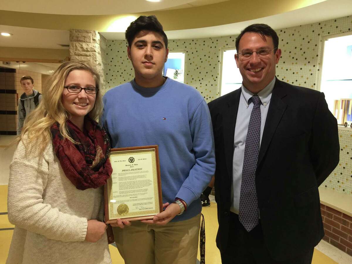 JLHS Key Club Co-Presidents Marissa Pollack (left) and Mike Jalaf (center) accept a city proclamation from Mayor Benjamin Blake last week.  The document proclaimed the citys support of Key Club International Week.