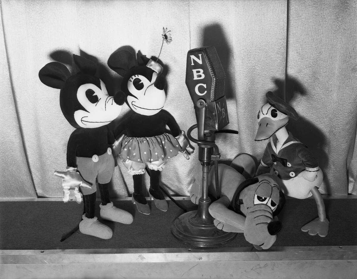 The "Mickey Mouse Theatre of the Air" radio show. Pictured from left to right are Mickey Mouse, Minnie Mouse, Pluto, and Donald Duck circa December 1937.