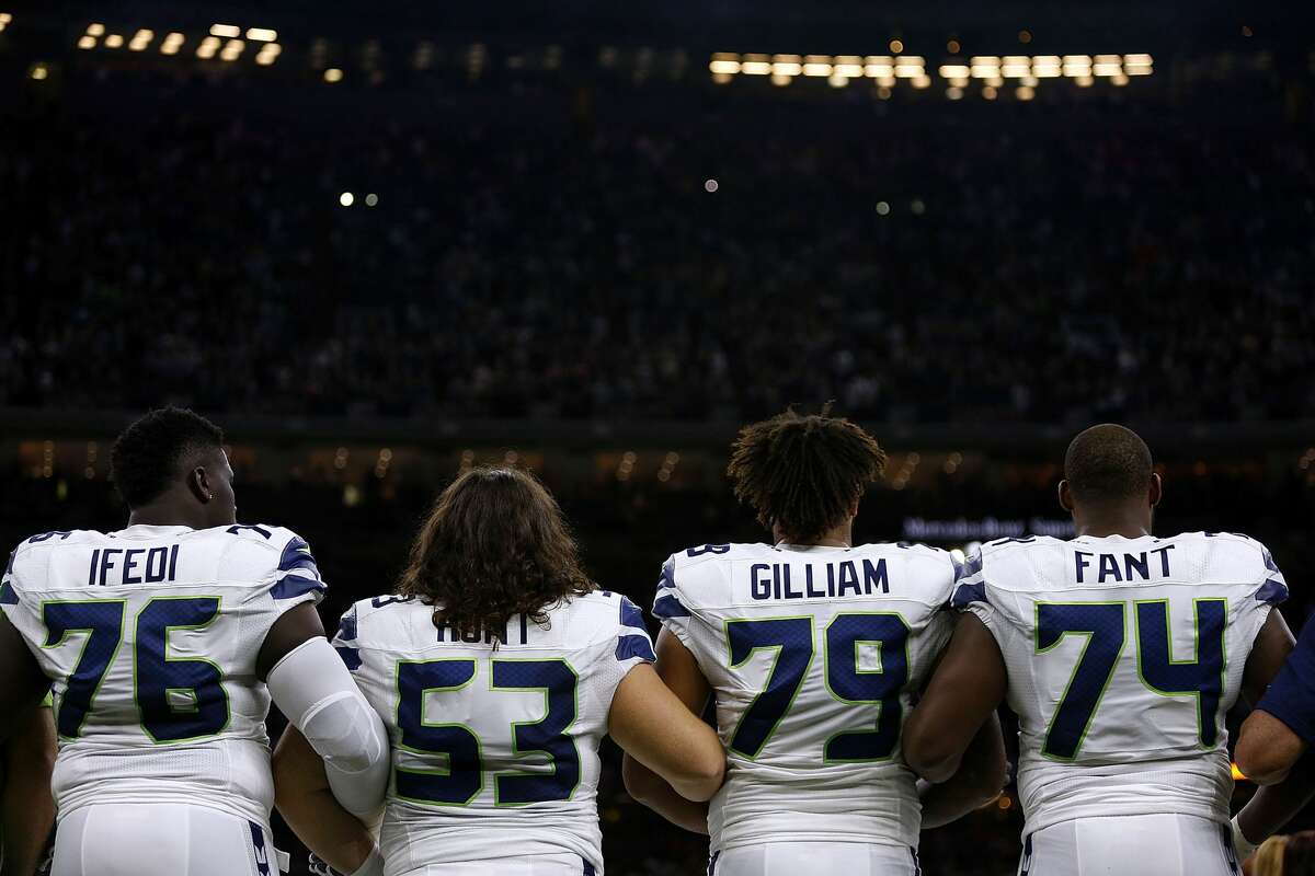 Germain Ifedi, Joey Hunt, Garry Gilliam and George Fant hold arms during the national anthem before the Seahawks' game against the New Orleans Saints at the Mercedes-Benz Superdome on October 30, 2016 in New Orleans, Louisiana. (Photo by Jonathan Bachman/Getty Images)