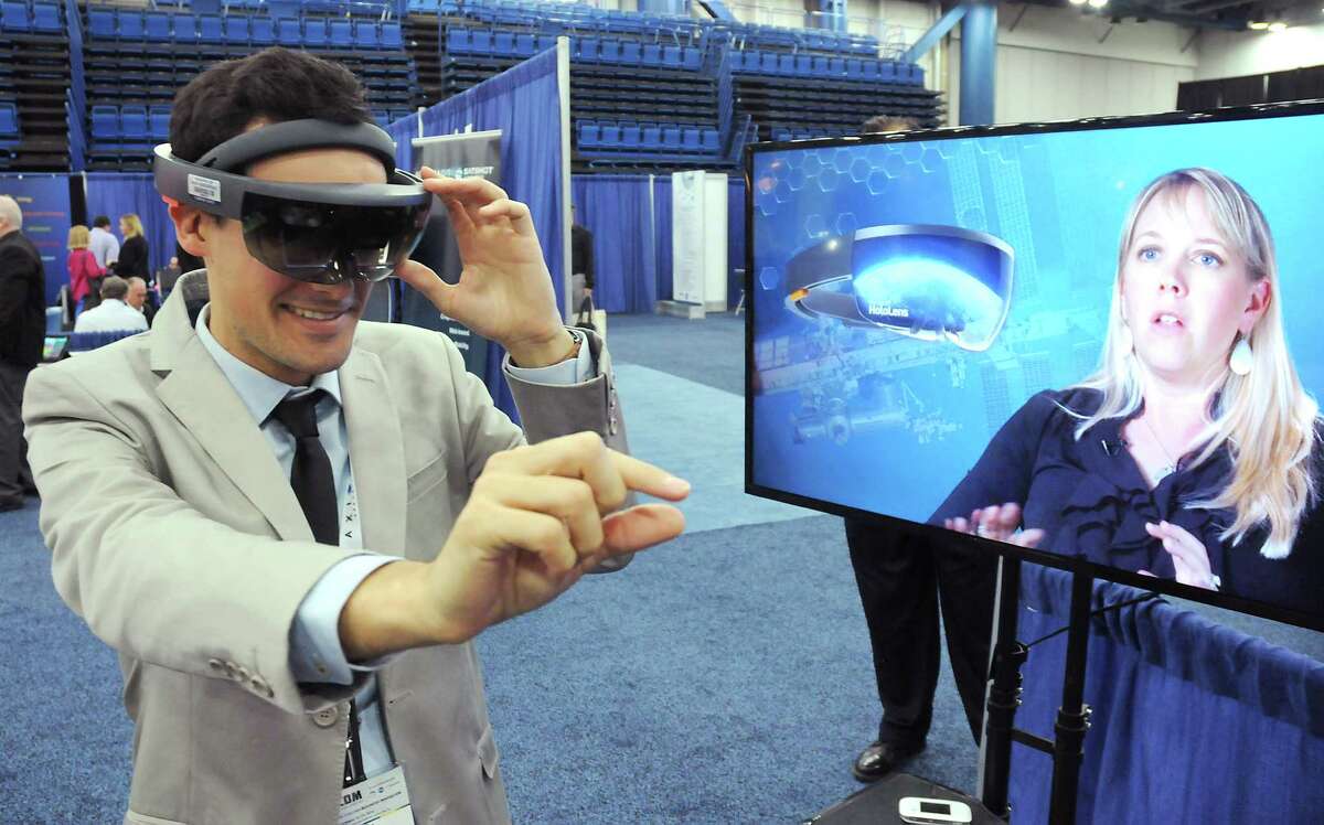 Robin Faideau from the French Office for Science and Technology tries out virtual reality goggles from Aexa at SpaceCom at the George R. Brown Convention Center Wednesday Nov. 16, 2016.(Dave Rossman photo)