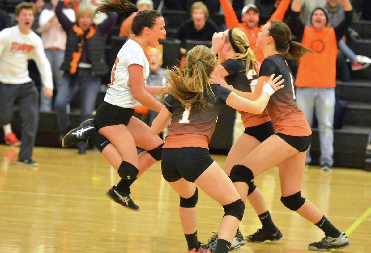 The Stamford girls volleyball celebrates after sweeping Amity in CIAC Class LL state semifinals on Wednesday night in Trumbull.