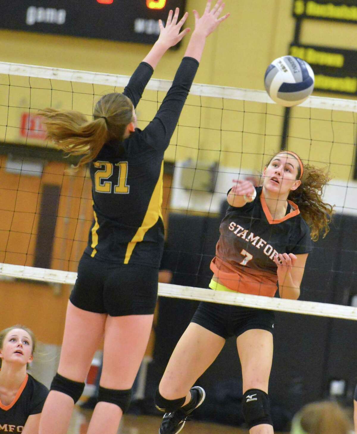 Stamford’s Andrea O’Connor sends the ball past Amity’s Abagail Harbinson during Wednesday’s Class LL semifinal at Trumbull. The Black Knights won 3-0.