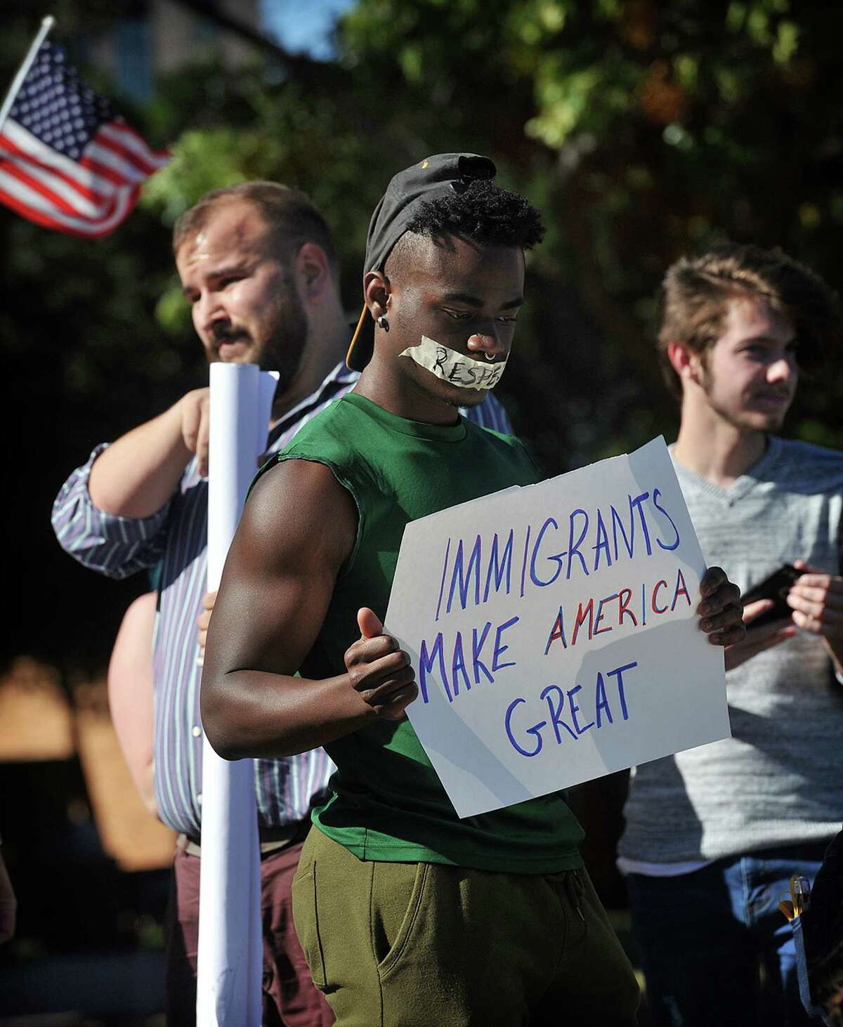 Midwestern State University nursing student Richard Brown was one of about 70 students who came out to stage a peaceful protest against hate, intolerance and president elect Donald Trump, on campus Wednesday afternoon in Wichita Falls, Texas. A smaller group held signs supporting Trump/Pence. (Torin Halsey/Wichita Falls Times Record News via AP)