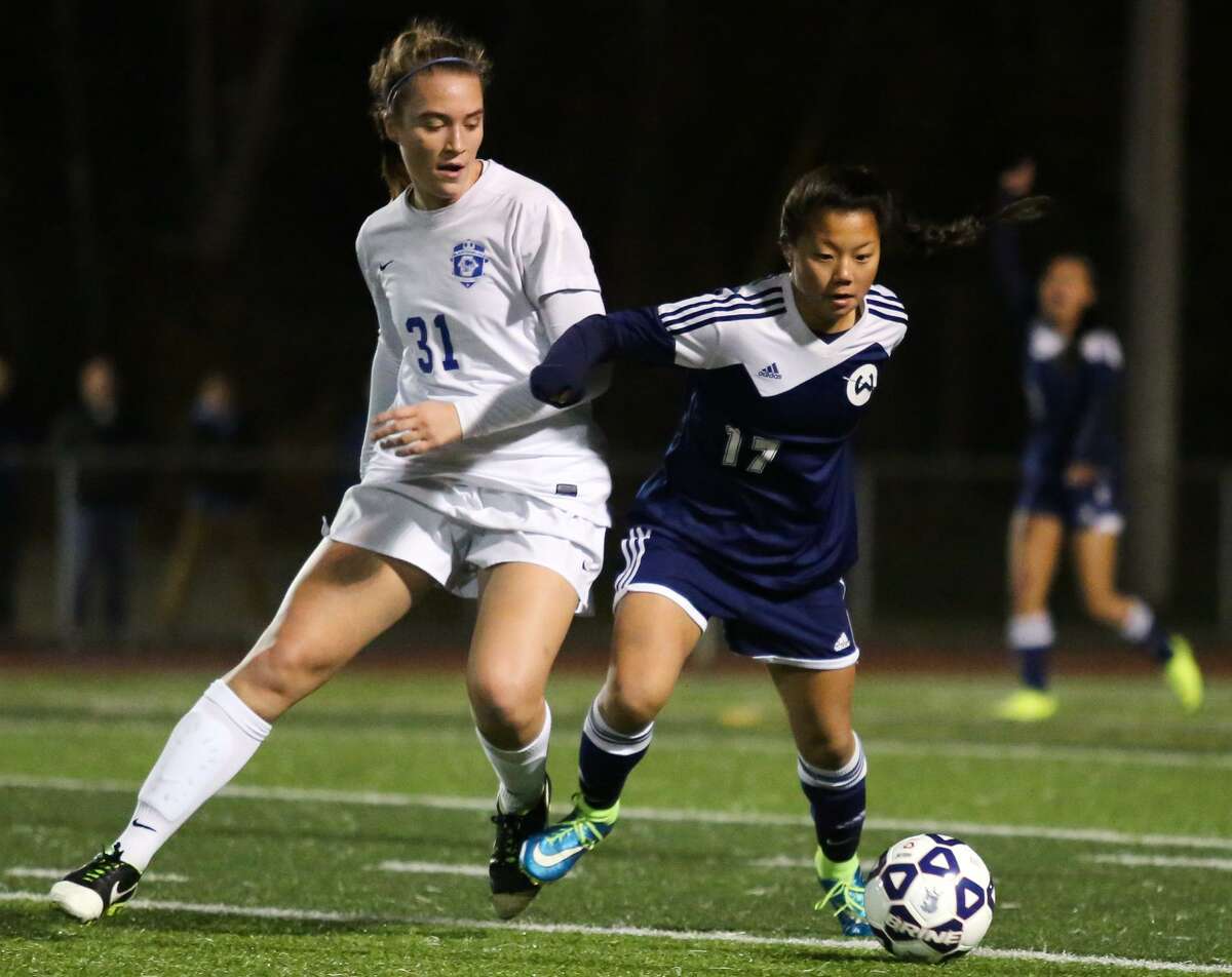 Wilton's Grace Rava pushes for the ball against Glastonbury during the Class LL girls soccer semifinals in West Haven, Conn. on Wednesday, November 16, 2016.