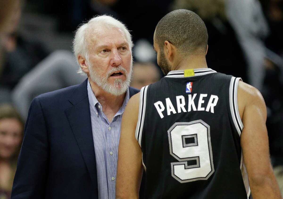 San Antonio Spurs coach Gregg Popovich talks with guard Tony Parker during the second half of the team's NBA basketball game against the Sacramento Kings in Sacramento, Calif., Wednesday, Nov. 16, 2016. The Spurs won 110-105. (AP Photo/Rich Pedroncelli)