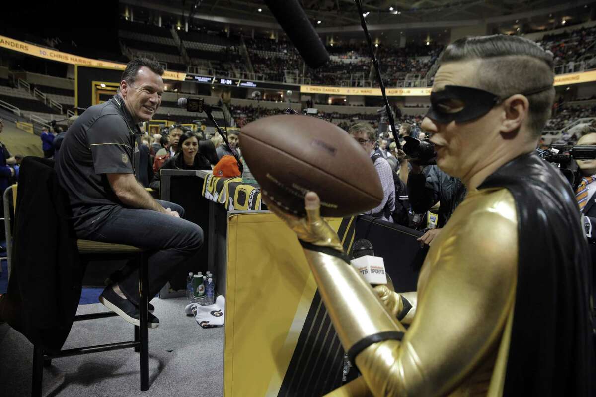 Pick Boy with the Nickelodeon Channel tries to get Broncos head coach Gary Kubiak to ask his football a question at the Super Bowl 50 Opening Night at SAP Center in San Jose, Calif., on Monday, February 1, 2016.