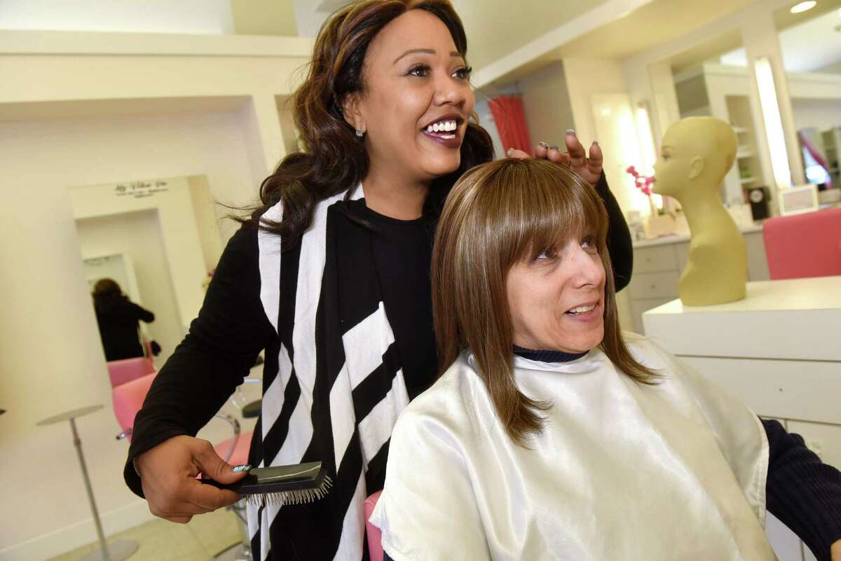 Kathy Marin of Valatie, right, tries on her wig with assistance from Kimberly "Kimora" Fray, a cosmatelogist and wig specialist, on Tuesday, Nov 8, 2016, at Rumors Salon and Spa in Latham, N.Y. (Cindy Schultz / Times Union)