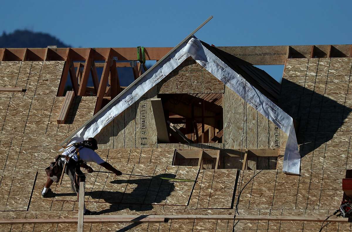 SAN RAFAEL, CA - NOVEMBER 17: A worker stands on the roof of a home under construction at a new housing development on November 17, 2016 in San Rafael, California. According to a report by the Commerce Department, housing starts surged 25.5% in October to an annual rate of 1.323 million. (Photo by Justin Sullivan/Getty Images)