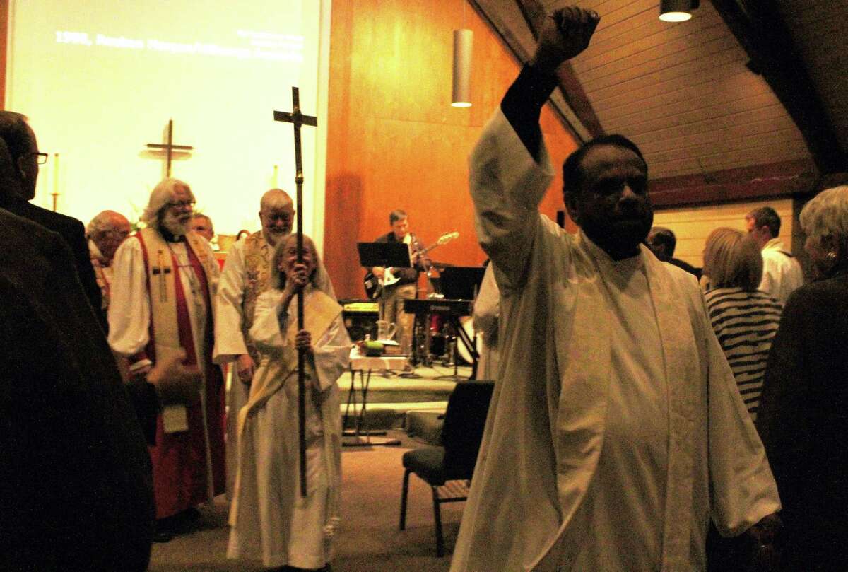 Rev. Canon George Kovoor moves and shakes to the music at the close of the celebration of his new ministry at St. Paul’s Church.