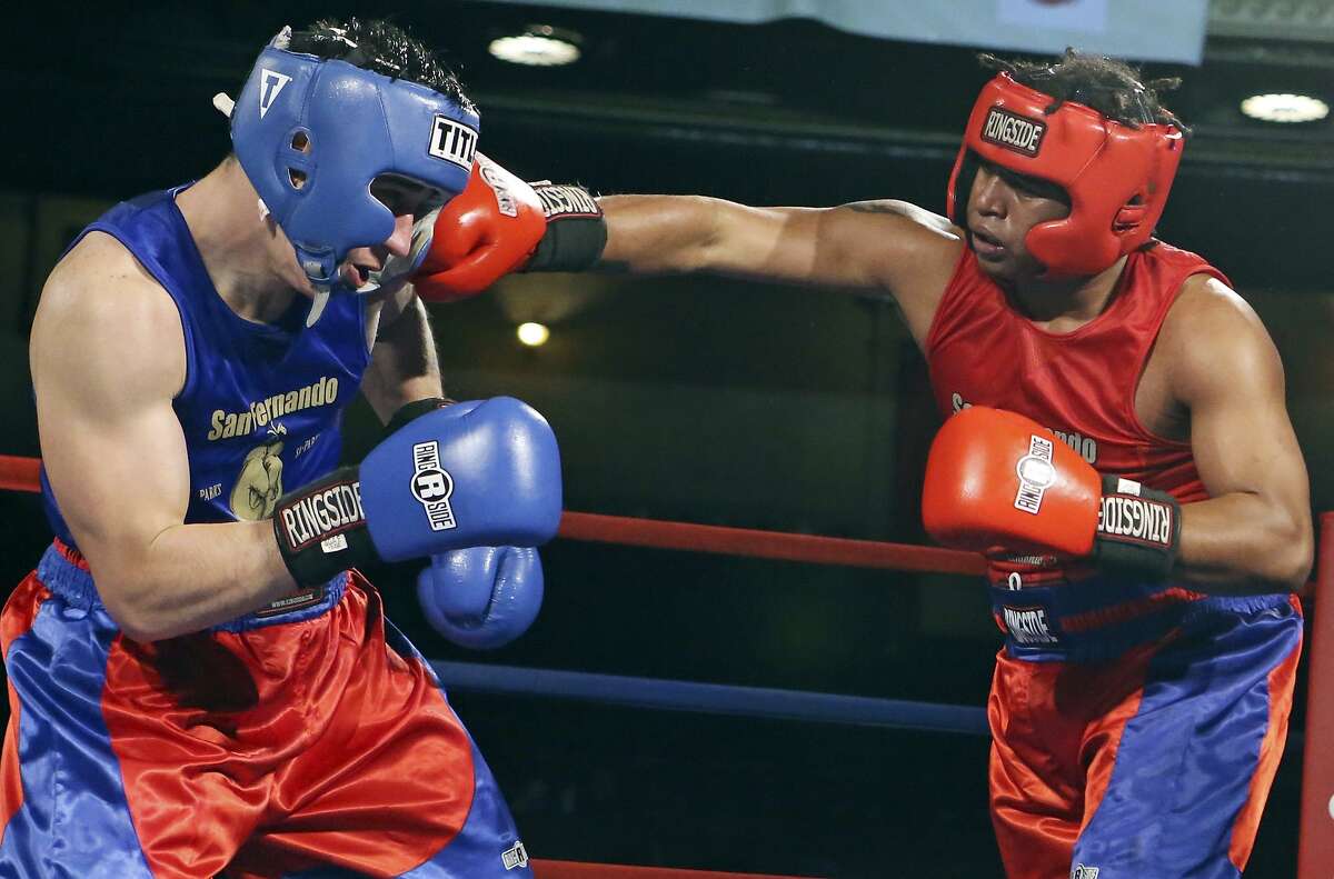 Christopher Pope (right) hits Herman Torres during their open heavyweight championship bout part of the 2016 San Antonio Regional Golden Gloves boxing tournament finals on Feb. 27, 2016 at the Scottish Rite Auditorium.