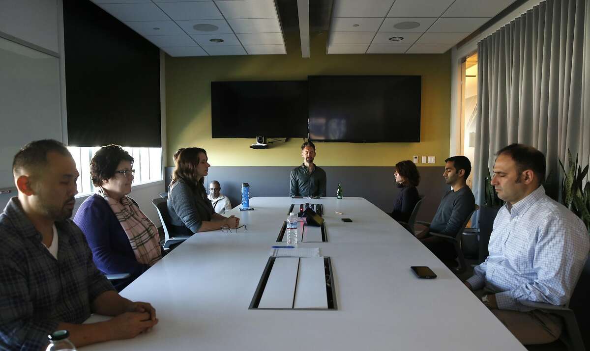 Chad Stose (center) leads a meditation session for employees of Ancestry.com in the company's offices in San Francisco, Calif. on Thursday, Nov. 17, 2016.