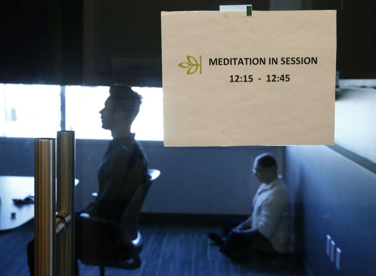 Chad Stose (left) leads a meditation session for employees of Ancestry.com in a conference room at the company's office in San Francisco, Calif. on Thursday, Nov. 17, 2016.