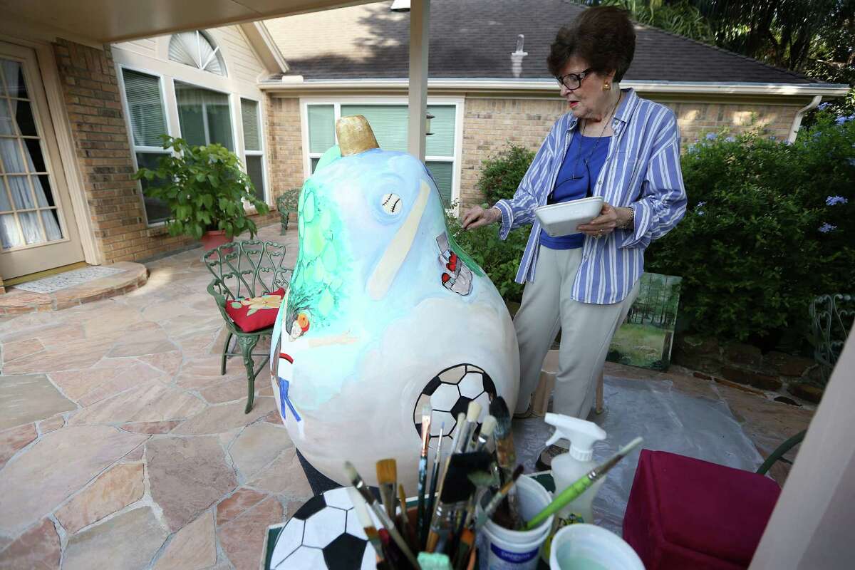 Josephine Eager decorates a pear sculpture on her patio Thursday, Aug. 4, 2016, in Pearland. Eager is one of several artists chosen to decorate pear sculptures that will be placed in various places around Pearland as a civic branding exercises. The city was Pearland was praised in a new Kinder Insitute report for using citizen surveys to prioritize projects. ( Steve Gonzales / Houston Chronicle )