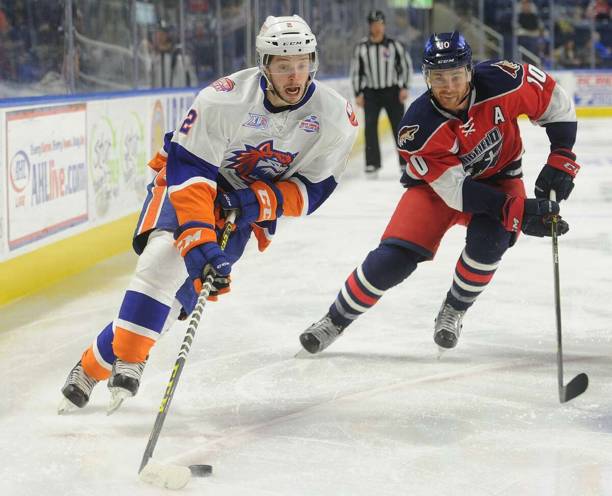 Sound Tiger Jesse Graham skates the puck into the offensive zone ahead of Springfield's Jordan Szwarz during Bridgeport's AHL hockey game with the Springfield Falcons at the Webster Bank Arena in Bridgeport, Conn. on Sunday, April 3, 2016.