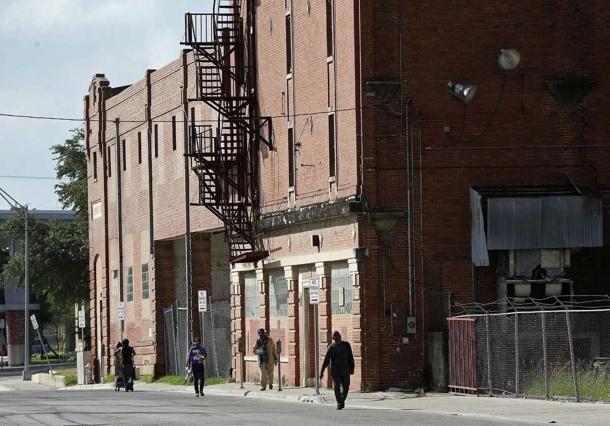 Pedestrians walk by the abandoned Scobey building on North Medina Street, Sunday, Oct. 30, 2016. The city took taking members of its housing bond committee on a Saturday bus tour of 12 of the 15 sites where the city could invest millions of dollars for affordable and mixed-income housing. The city is considering its first housing bond ever, a $20 million initiative that will be on the ballot in May. But many officials fear there won't be enough support for the bond, and already there's concern that members of the housing bond committee itself oppose spending the money for this purpose.