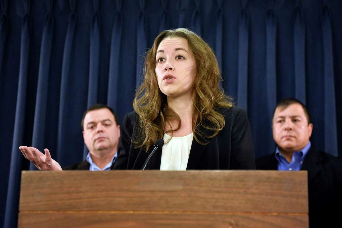 Sarah Rogerson, director of the Immigration Law Clinic, center, talks about the uncertainty for millions of undocumented immigrants, especially those in the Deferred Action of Childhood Arrivals program, on Wednesday, Nov 16, 2016, at the Legislative Office Building in Albany, N.Y. Joined by Assemblyman Luis Sepulveda, left, and Guillermo Martinez, legislative director of the Puerto Rican-Hispanic Task Force, they called on President Obama to pardon and protect all DACA enrollees. (Cindy Schultz / Times Union)