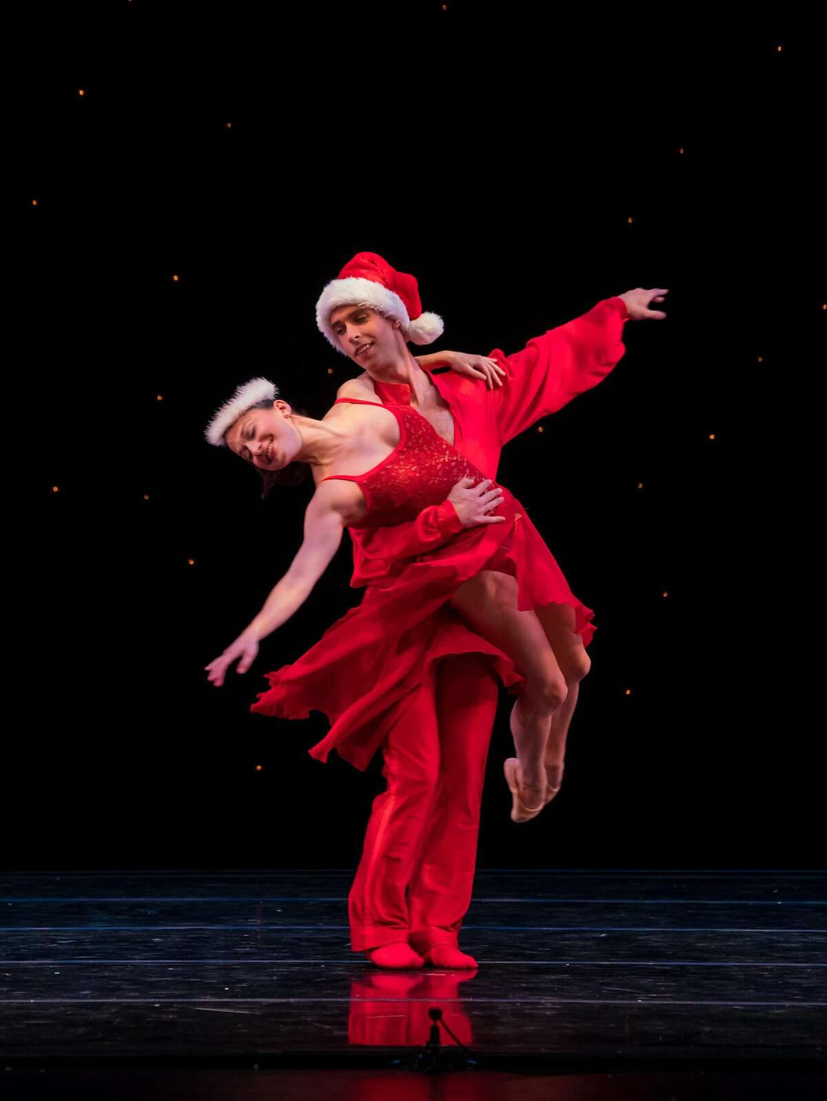 Ben Needham-Wood lifts Terez Dean frolic in "White Christmas" - a new work (choreographed by Ben Needham-Wood after Michael Smuin) for Smuin's annual The Christmas Ballet, playing through Dec. 24 in Walnut Creek, Carmel, Mountain View, and San Francisco. Photo credit: Keith Sutter