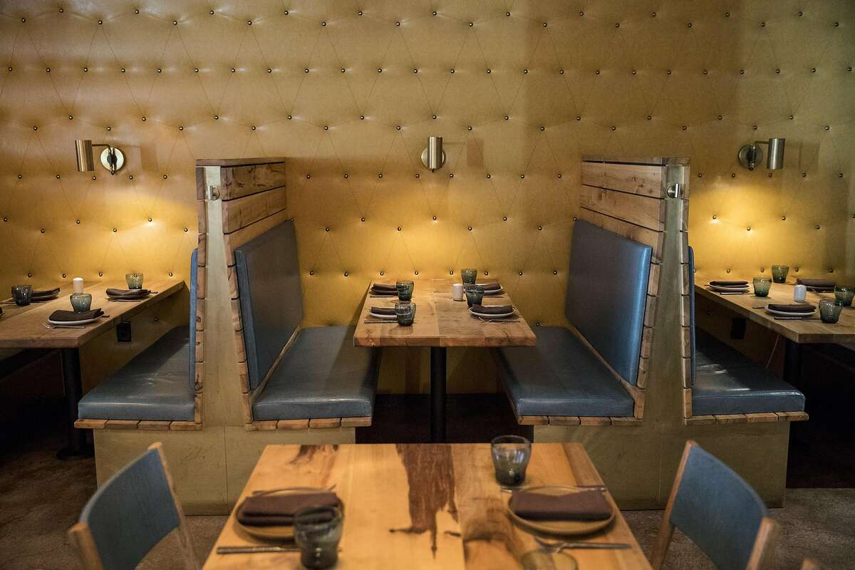 A part of the dining room that features intimate booths and leather lined walls is seen at Bellota, a new Spanish cuisine restaurant in SoMa by the Absinthe Group, in San Francisco, Calif.