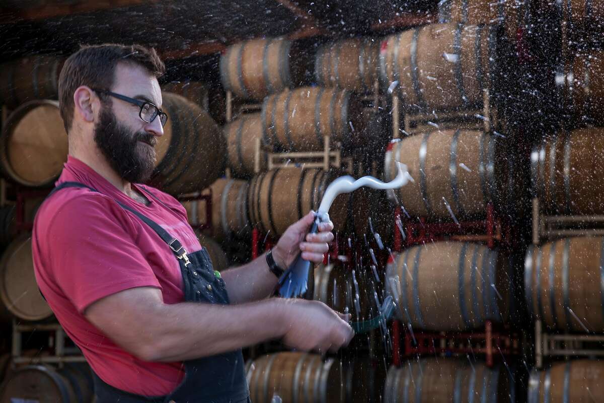 Winemaker Michael Cruse of Cruse Wine Co. and Ultramarine Wines disgorging a bottle of sparkling wine at his winery in Petaluma, California, USA 17 Nov 2016. (Peter DaSilva/Special to The Chronicle)