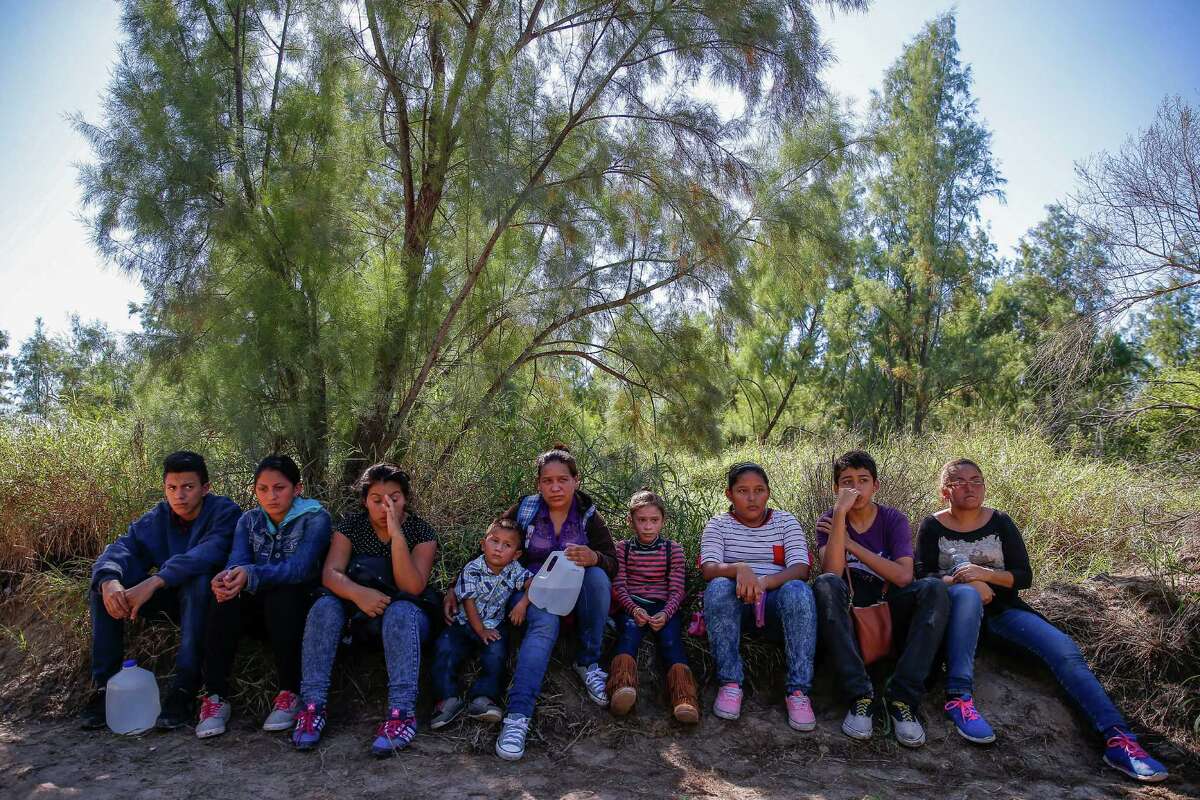 A group of immigrants sit next to a road after they crossed into the United States and were detained by Border Patrol Wednesday, Nov. 16, 2016 in McAllen. Most immigrants are arriving from El Salvador, Honduras and Guatemala where they are escaping violence and poverty. They hope to be found by border patrol to be processed, released and begin the process to stay in the country.