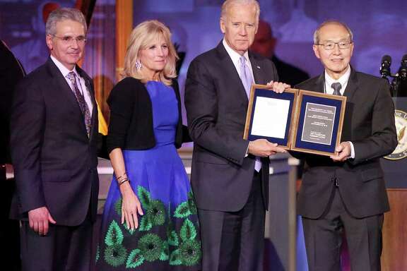 United States Vice President Joe Biden and his wife, Dr. Jill Biden, receive a special plaque commemorating the new Beau Biden Chair for Brain Cancer Research from Dr. Alfred Yung and University of Texas MD Anderson Cancer Center President Dr. Ronald DePinho at the institution's 75th Anniversary Gala on Thursday, November 10, in Houston.  Biden's son, Beau Biden, was admitted and treated at MD Anderson for brain cancer in 2013. (Yi-Chin Lee / Houston Chronicle )