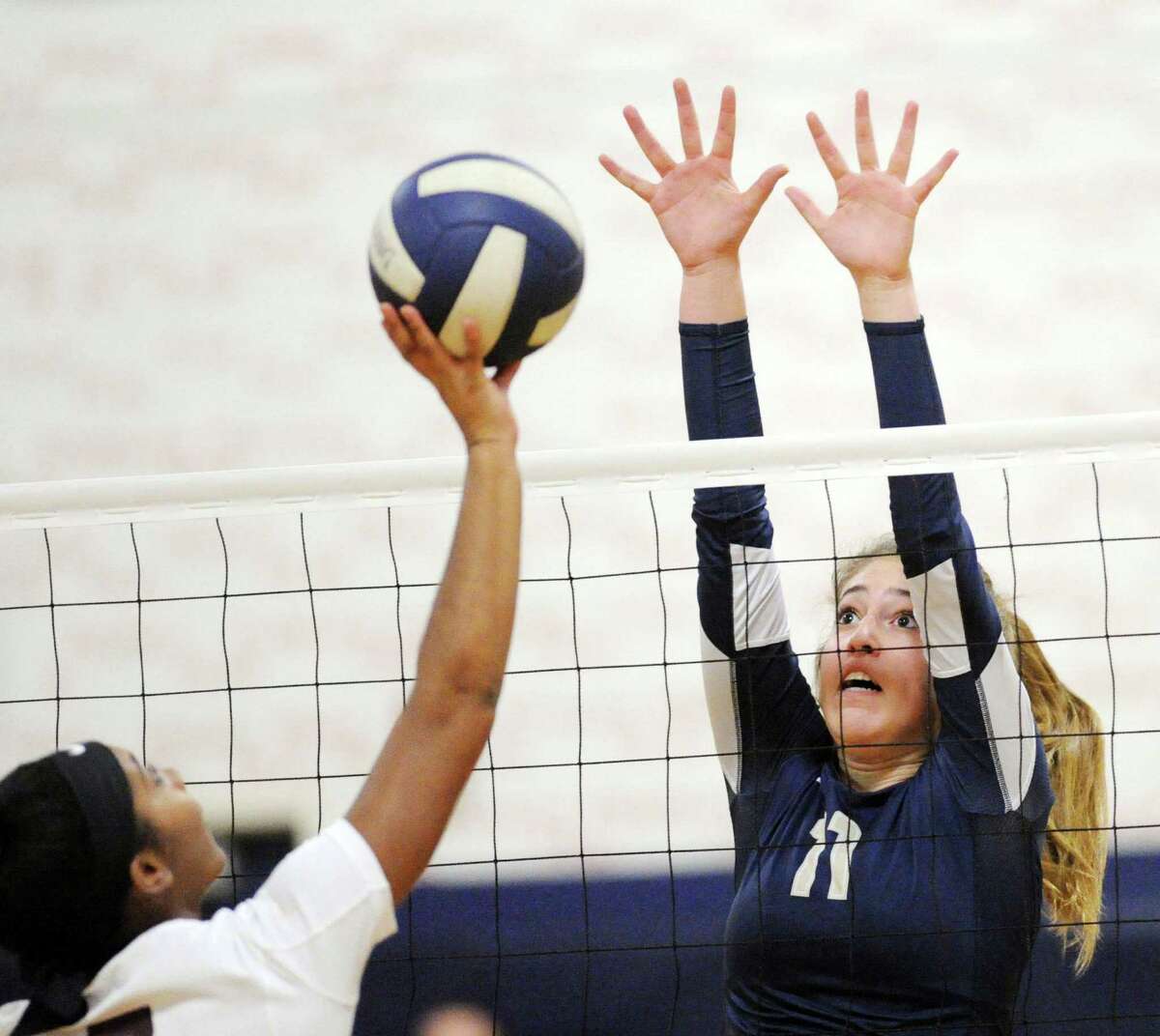 St. Luke's Caitlyn Hughes, left, attempts to get a shot past King's Ava Robinowitz (11) during the NEPSAC girls volleyball semifinal match between King School and St. Luke's School at King in Stamford, Conn., Friday, Nov. 18, 2016. King advanced with a 3-0 win over St. Luke's.