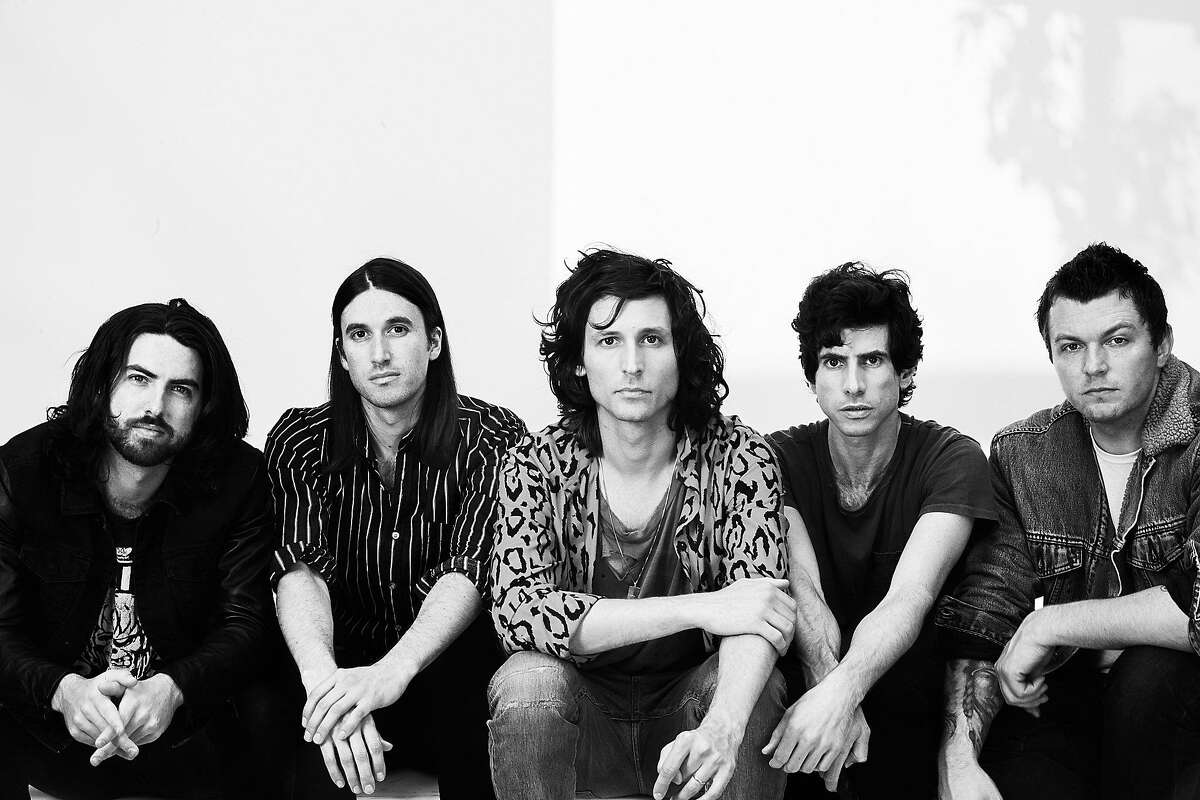 Nick Valensi (center), of the Strokes, fronts CRX