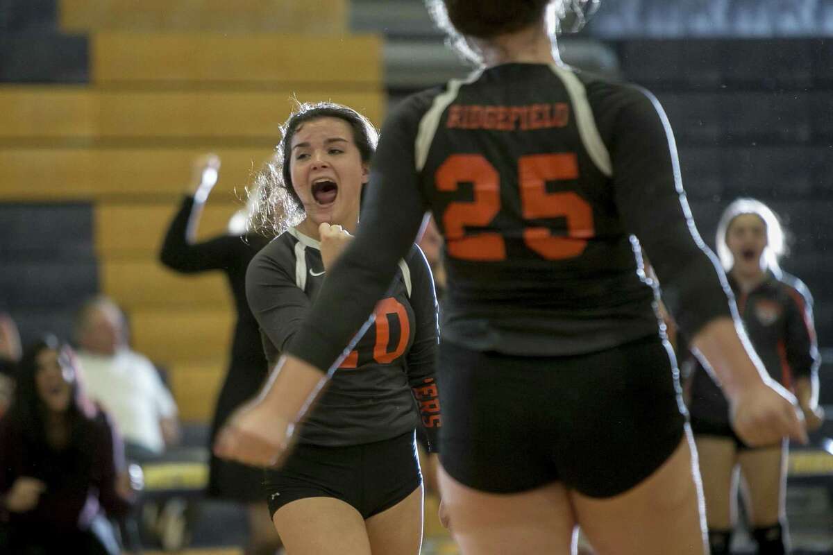 Ridgefield’s Kathryn Linekin, reacts to scoring on Stamford in an early game of the Class LL girls volleyball final between Ridgefield and Stamford in East Haven on Saturday.