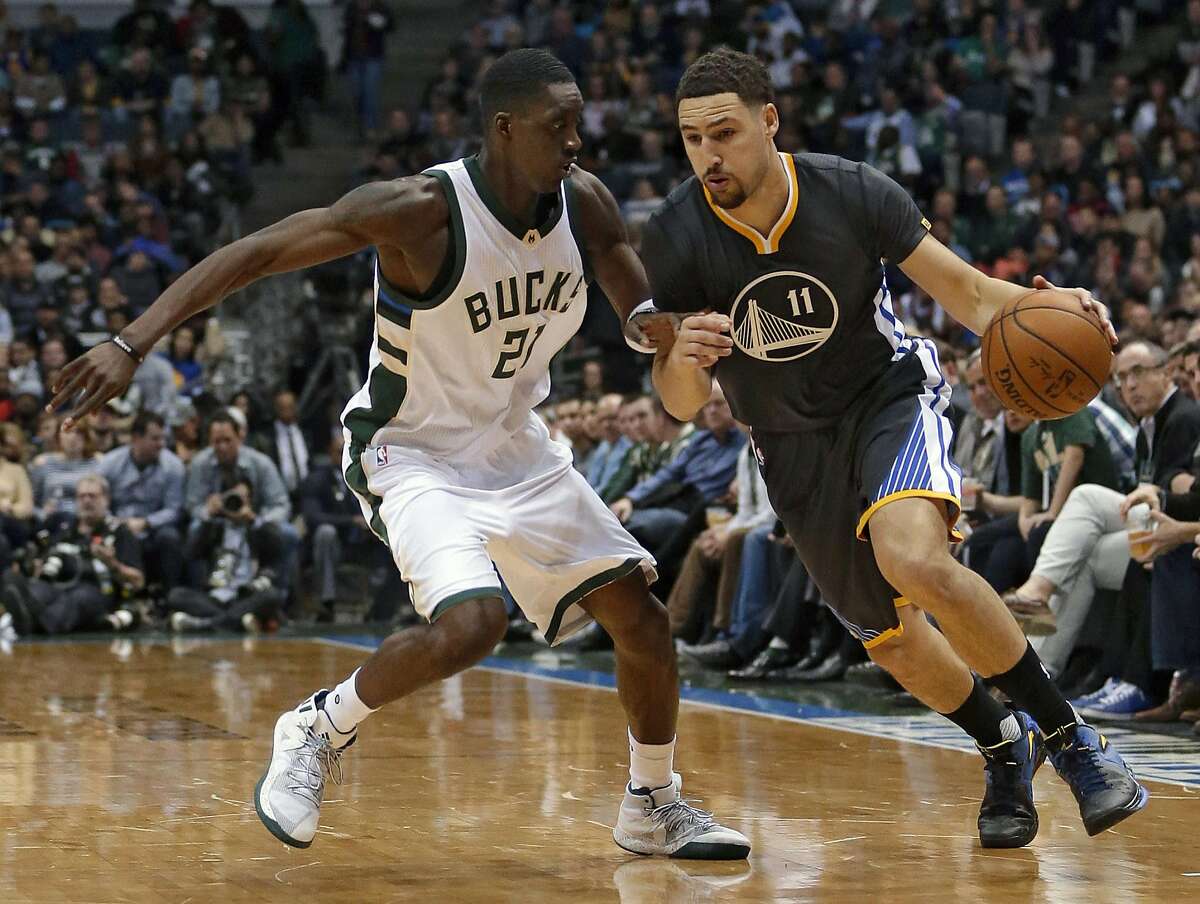 Golden State Warriors' Klay Thompson (11) drives against Milwaukee Bucks' Tony Snell during the first half of an NBA basketball game Saturday, Nov. 19, 2016, in Milwaukee. (AP Photo/Aaron Gash)