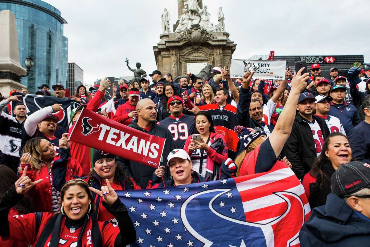 Houston Texans fans gather for a Traveling Texans photo at the Angel de la Independencia monument on Sunday, Nov. 20, 2016, in Mexico City.