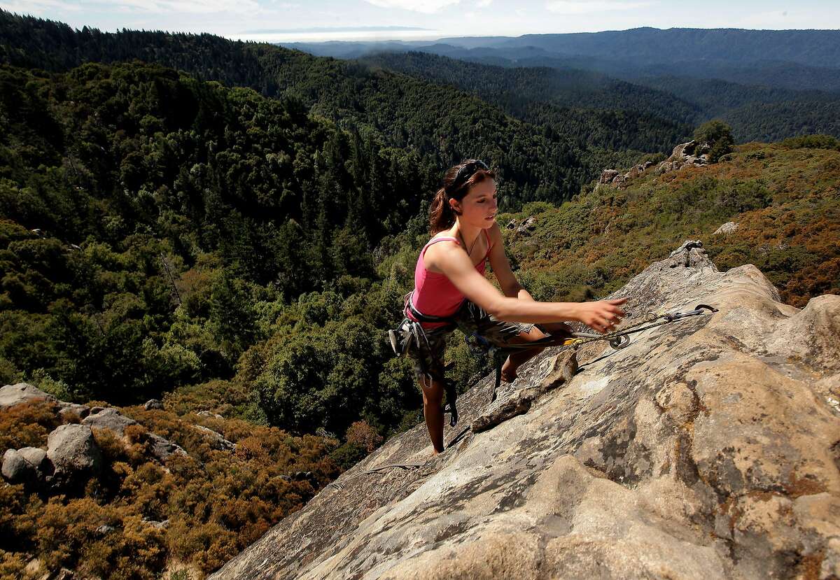 Holly Tate, of Santa Cruz climbs Goat Rock, a popular climbing spot at Castle Rock State Park on Wednesday August 17, 2011, in Los Gatos, Ca. Castle Rock is one of the Bay Area parks currently on the closure list which may close down due to California budget cuts.