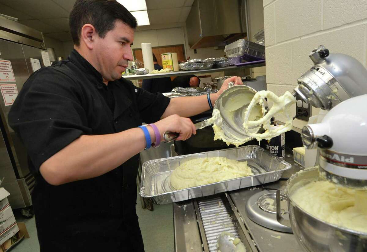 Chef Roman Calderon whips up a mountain of mashed potatoes as the crew from Chicken Joe’s restaurant in Cos Cob help prepare the Community Thanksgiving Luncheon at Cornerstone Community Church on Sunday. Turkey and all the trimmings were served up to about 300 people by church members and volunteers. It was the 17th year for the event.