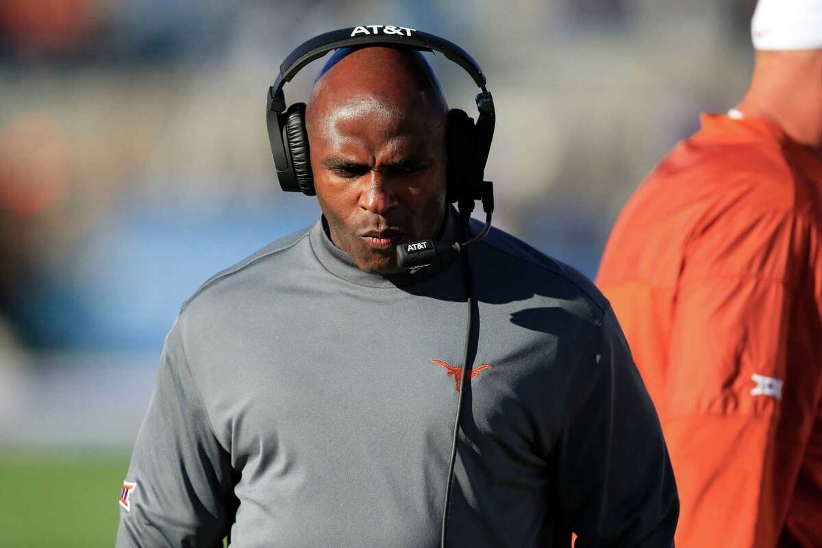 Texas head coach Charlie Strong walks the sideline during the first half of an NCAA college football game against Kansas in Lawrence, Kan., Saturday, Nov. 19, 2016. (AP Photo/Orlin Wagner)