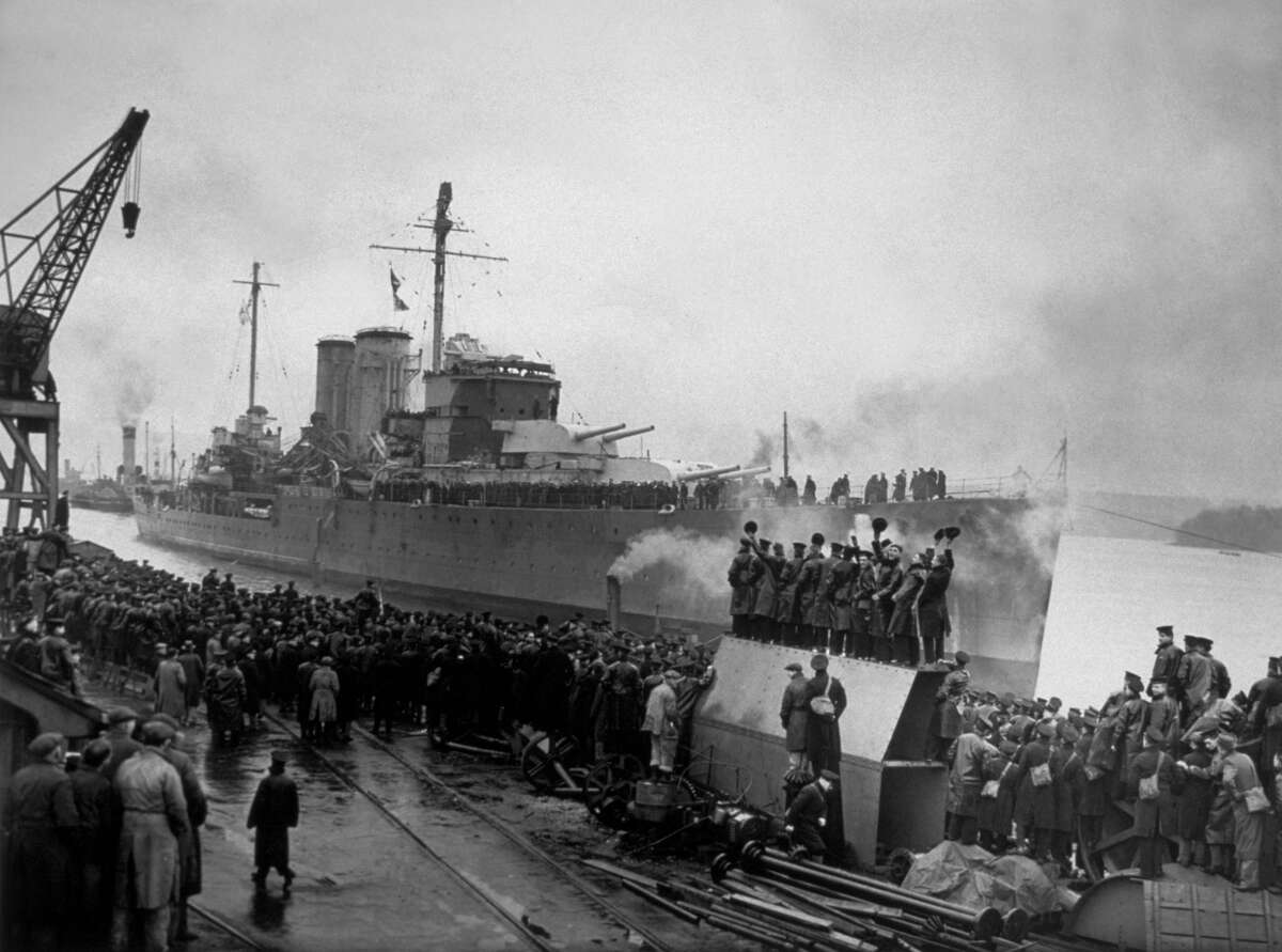 Crowds cheer the HMS Exeter in 1940. Take a look back at the ship during the years before it sank during WWII. 