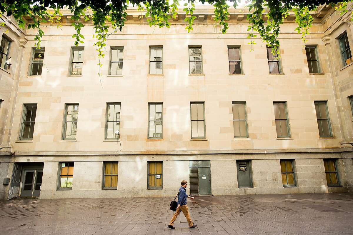 A pedestrian passes the Old Mint building at 5th and Mission Streets in San Francisco on Monday, Nov. 21, 2016.