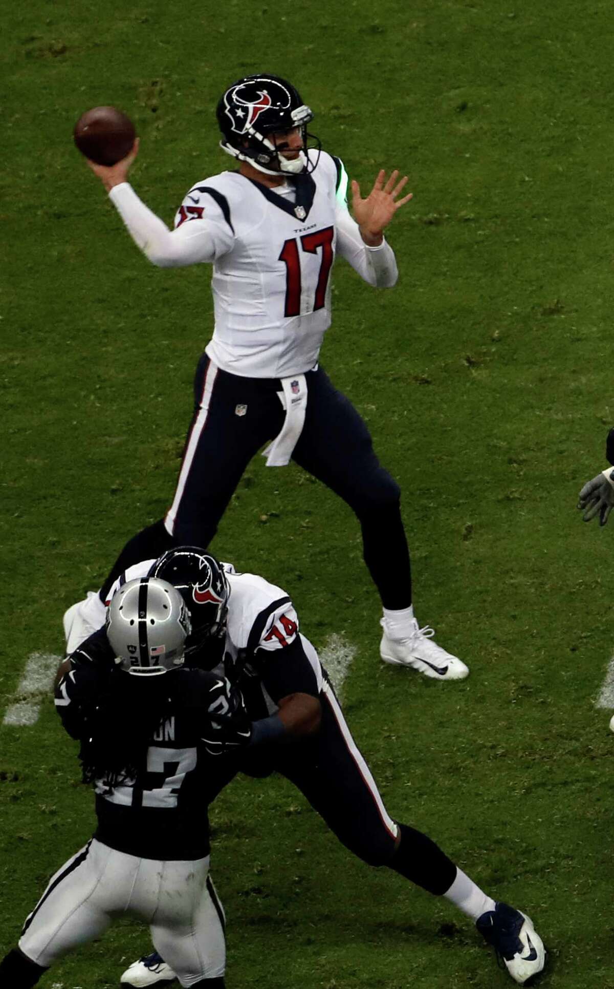 A green laser hits the jersey of Houston Texans quarterback Brock Osweiler as he looks to throw a pass during the second half of an NFL football game Monday, Nov. 21, 2016, in Mexico City. (AP Photo/Dario Lopez-Mills)