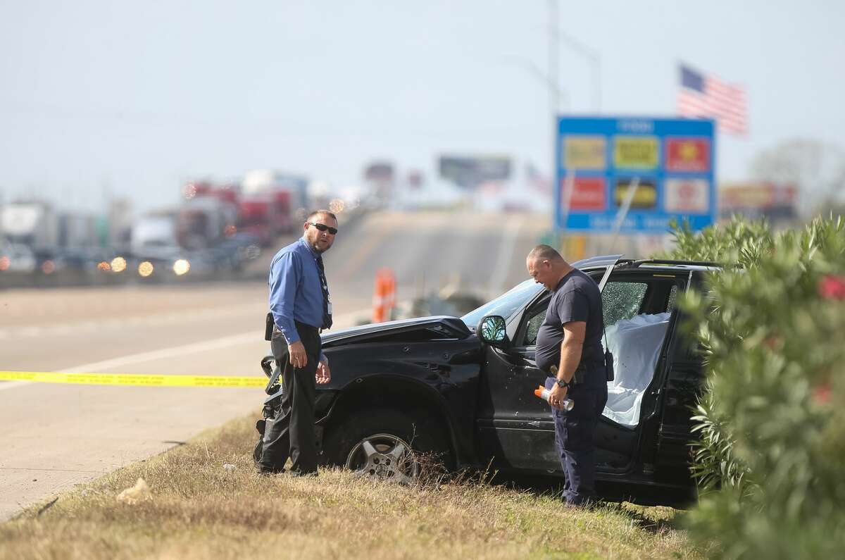 Authorities investigate the scene where a police chase ended in a crash and an officer-involved shooting on I-10 near Sjolander Road in Baytown, Tuesday, Nov. 22, 2016.