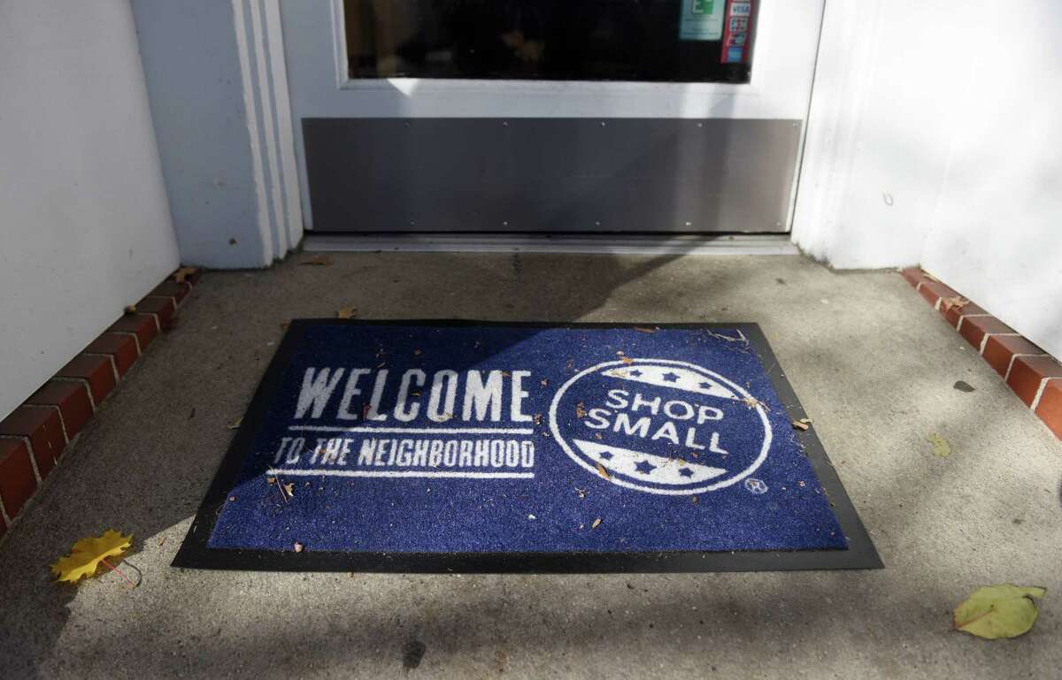A "shop small" doormat is displayed outside Greenwich Cheese Company in the Cos Cob section of Greenwich, Conn. Tuesday, Nov. 22, 2016. Small Business Saturday, created by American Express, is this Saturday. To encourage customers to shop locally, the Greenwich Chamber of Commerce distrubuted "shop local" bags to select stores.