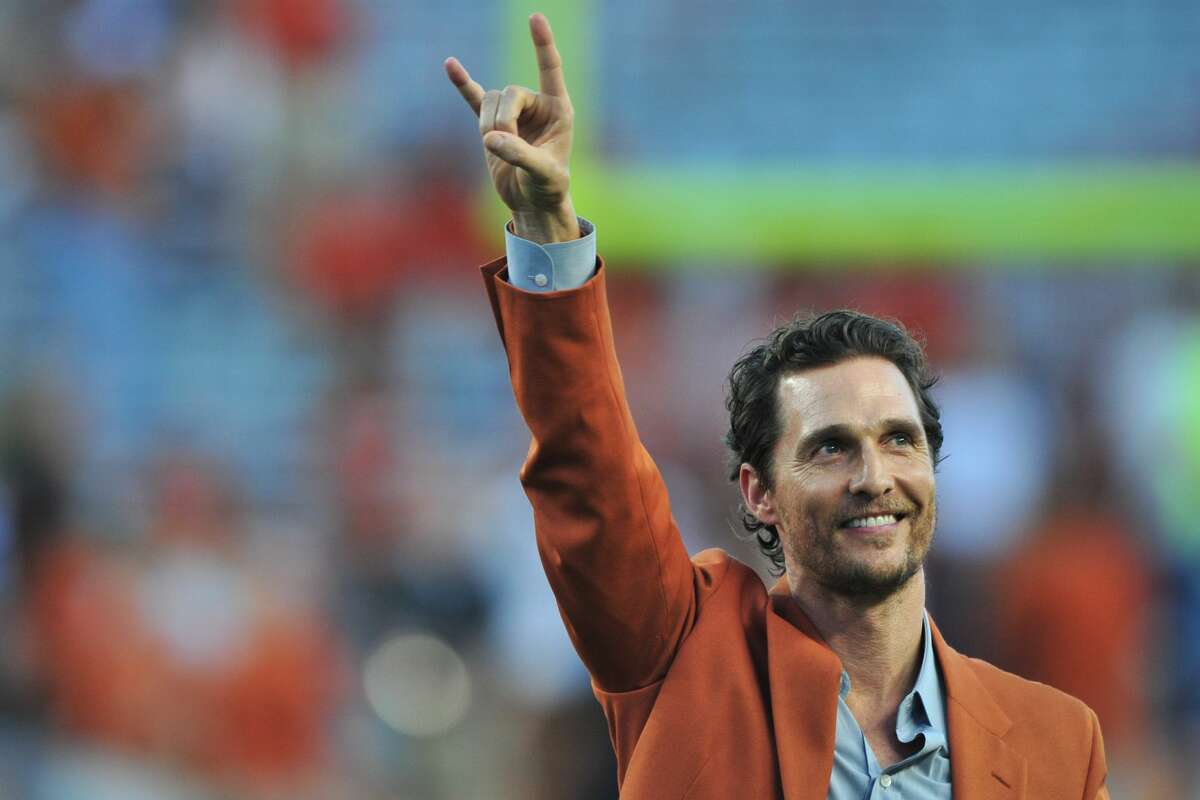 Matthew McConaughey throws his horns up before kickoff between the Texas Longhorns and Iowa State Cyclones on Oct. 18, 2014 at Darrell K Royal-Texas Memorial Stadium in Austin.