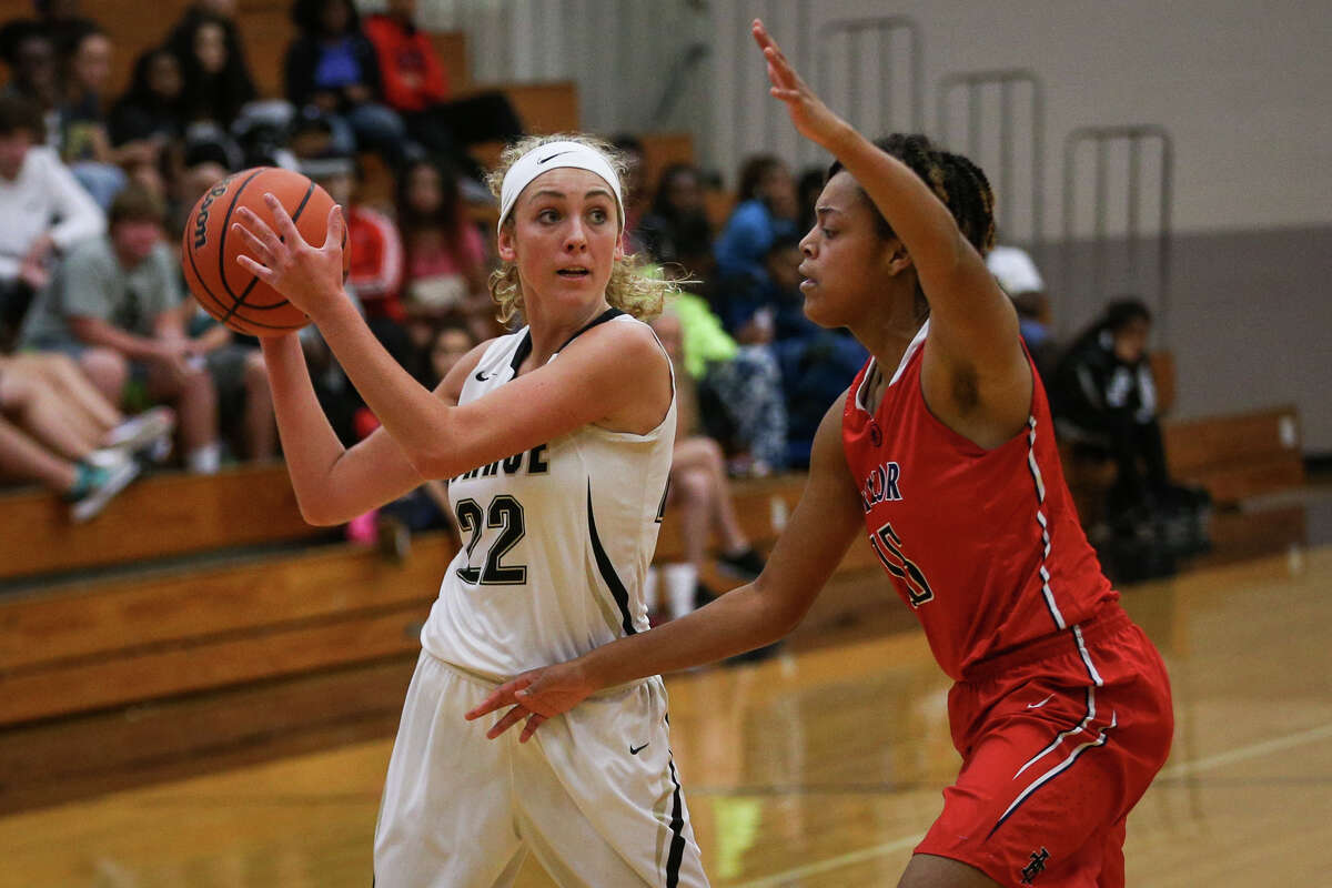 Conroe's Riley Halloran (22) looks to pass as Katy Taylor's Jawain Caston (15) defends during the varsity girls basketball game on Tuesday, Nov. 22, 2016, at Conroe High School. (Michael Minasi / Chronicle)